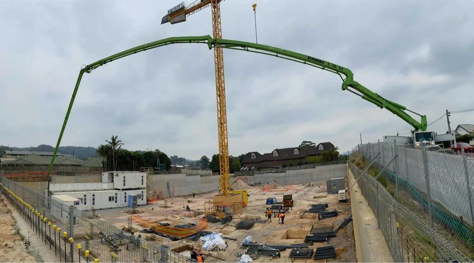 A boom pump articulated over a construction deck