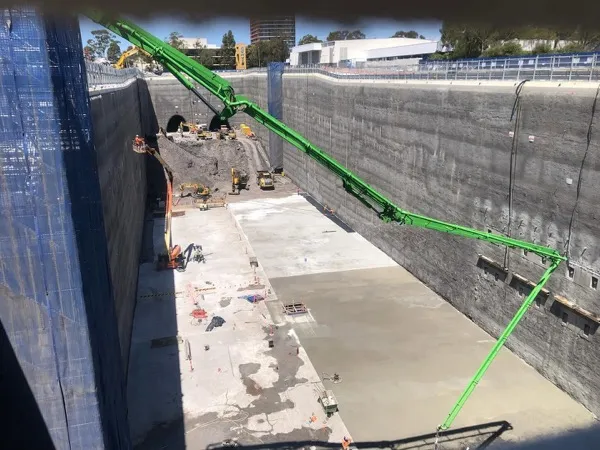 A boom reaching down into a deep dive structure pour