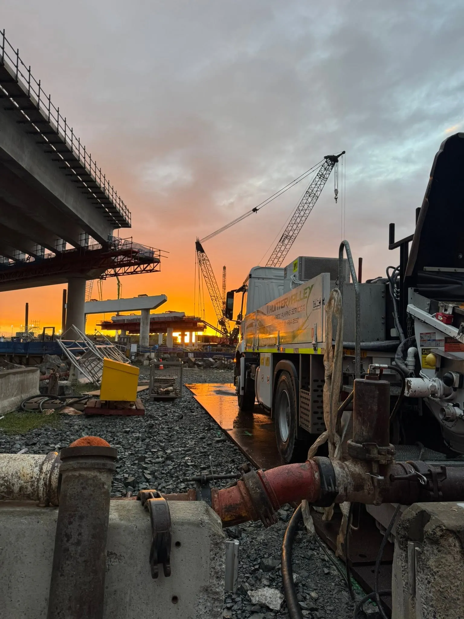 The barge mounted placing boom working a headstock pour at sunset